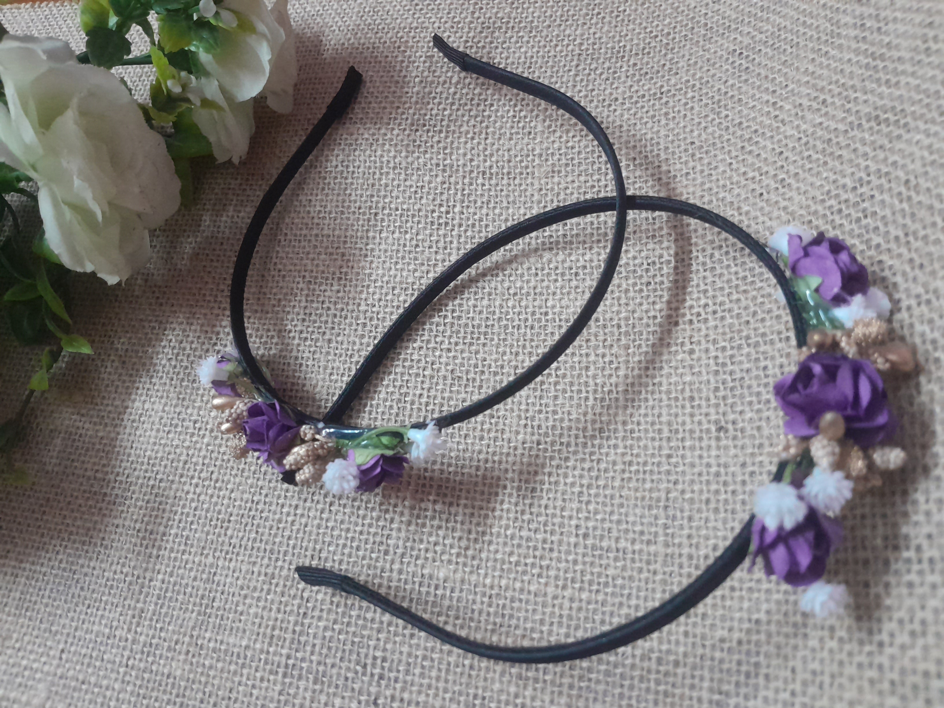 Black headband with purple floral decorations 