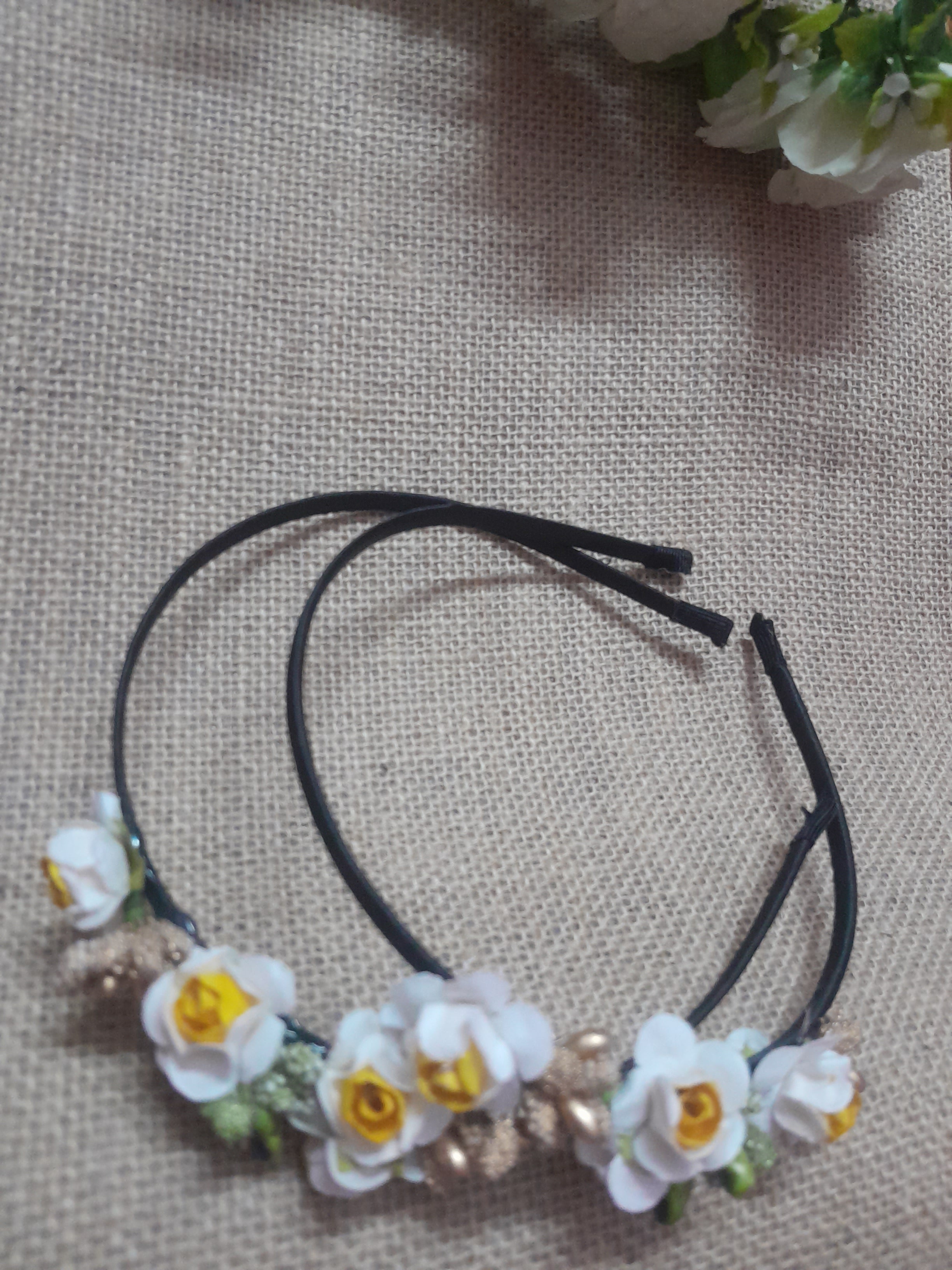 Black headband with White and yellow floral decorations